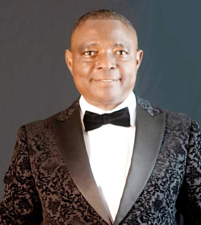 Portrait of Dr. Victor Eghujovbo in a patterned dinner jacket and bow tie
